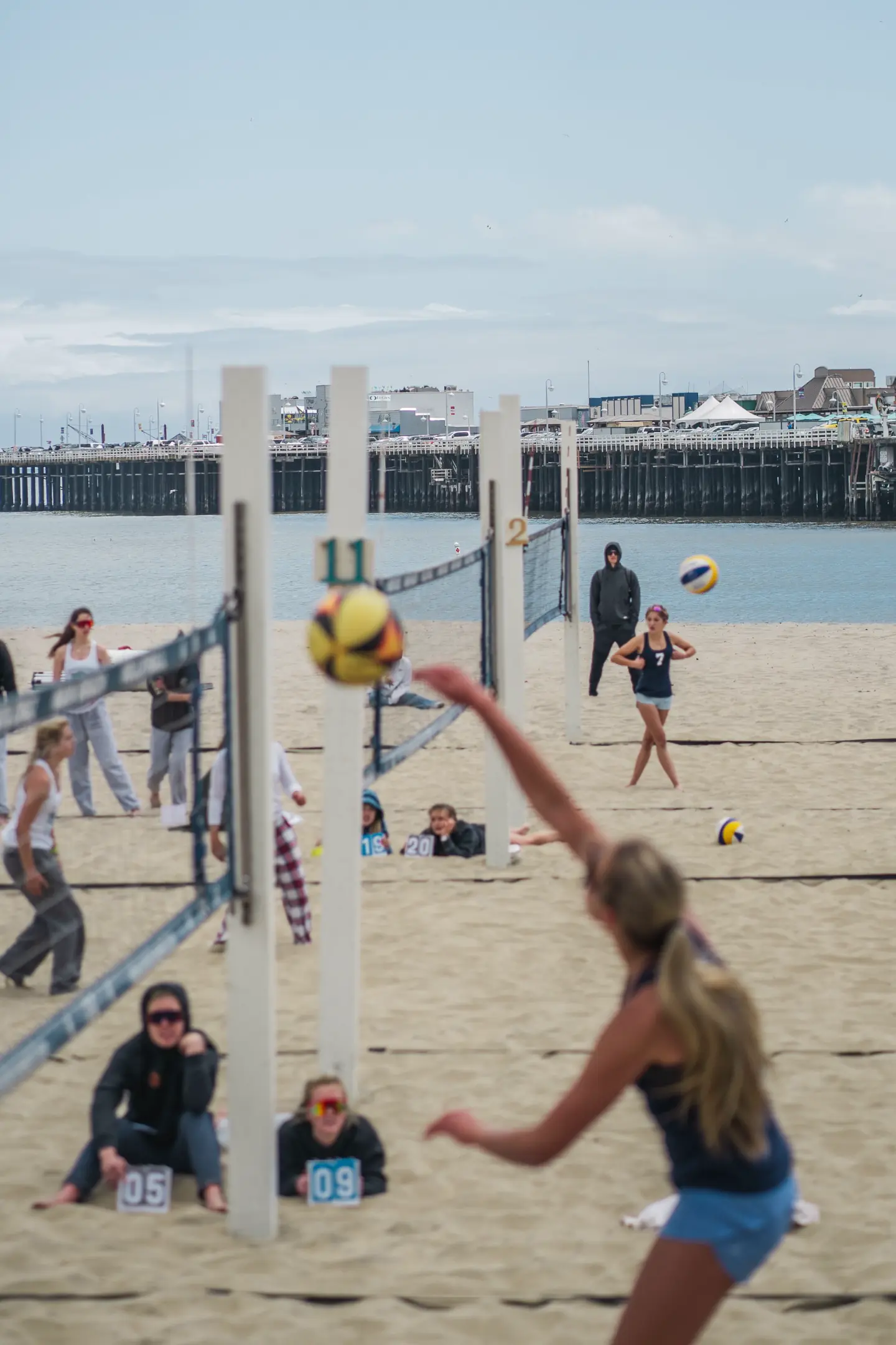 Beach volleyball player spiking the ball