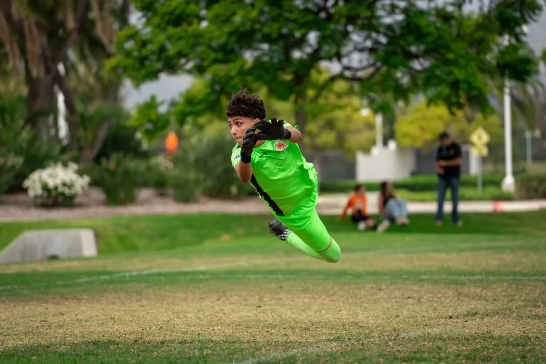 Goalkeeper diving full stretch for a save