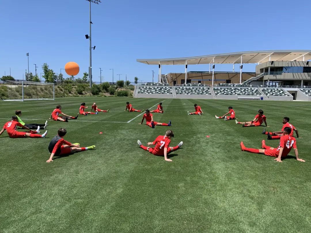 Youth soccer team stretching on the field before a game